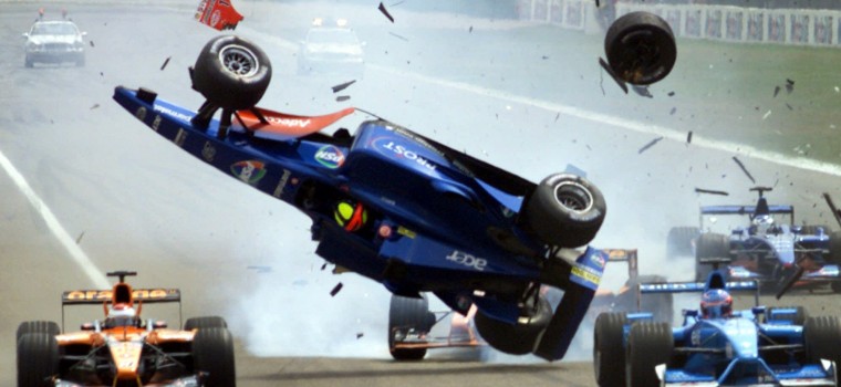 Prost racer Brazilian Luiciano Burti is up in the air while debris flies around after a crash at the start of the German Formula 1 Grand Prix at the Hockenheim track, Germany, Sunday, July 29, 2001. Michael Schumacher, the defending series champion and points leader, was force to quit the race. His brother Ralf went on to win. (AP Photo/Thomas Kienzle)